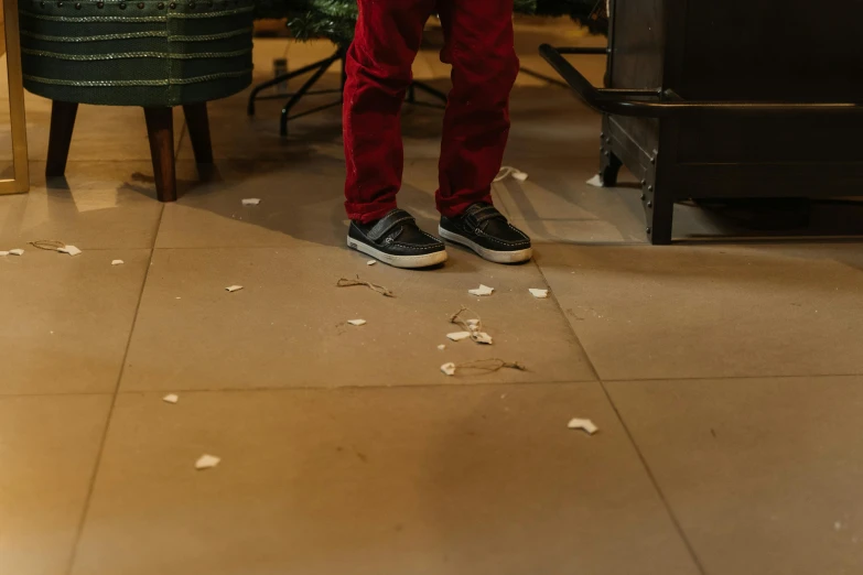 a man standing in the middle of a living room with his legs crossed