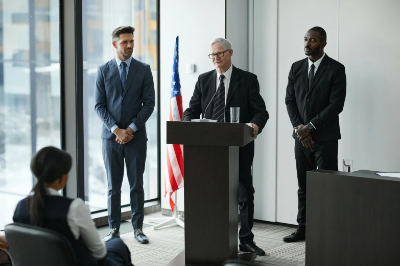 a group of men standing around a podium