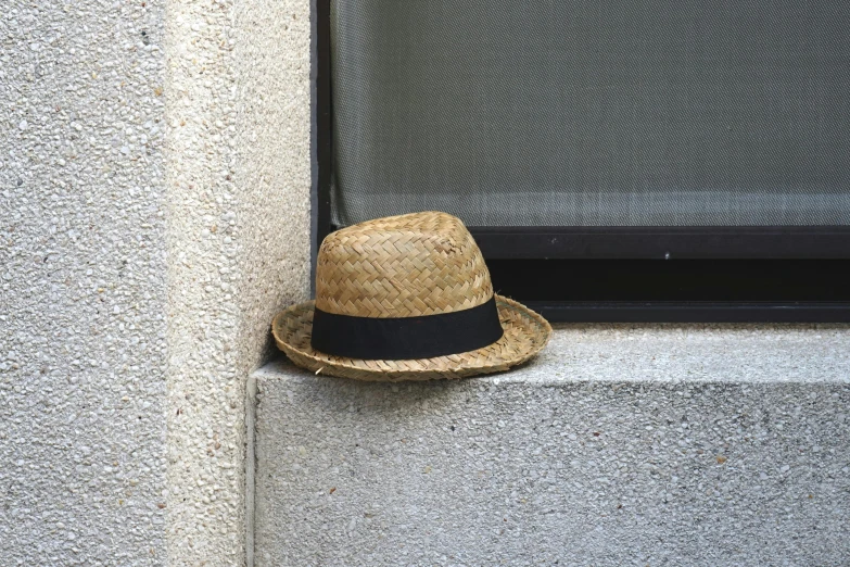 an old hat is propped against a window