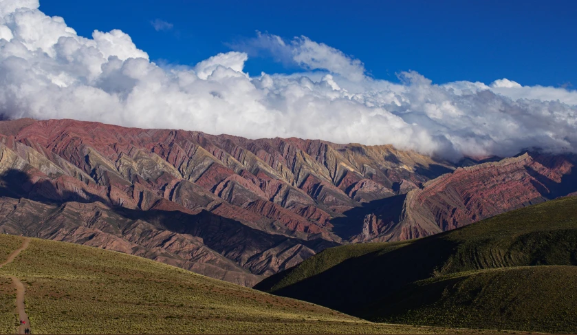 a vast area of rolling hills under a beautiful cloudy sky