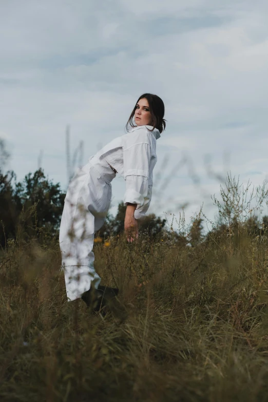 a person in the field kicking around with their legs up