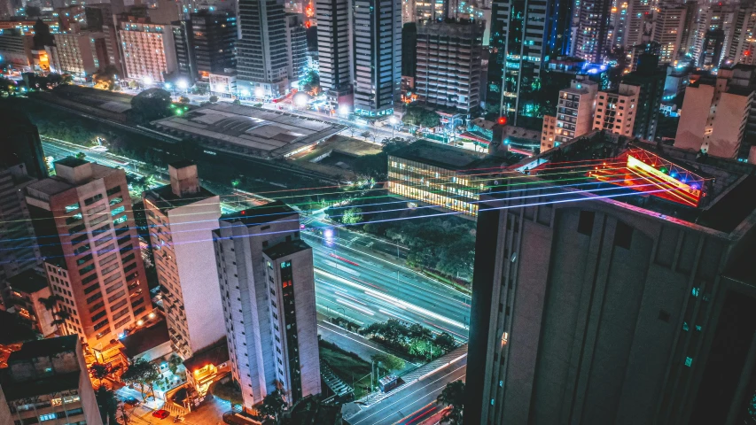 a busy city street is lit up at night