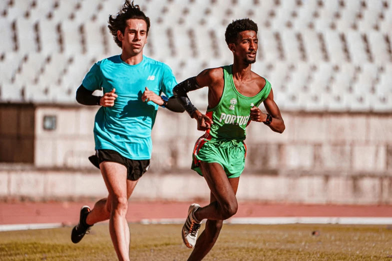 two men running in the field at a competition