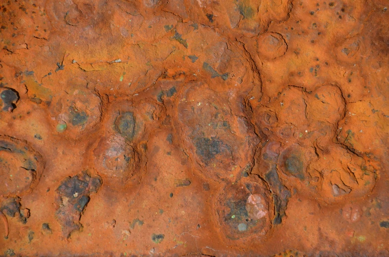 a rusty surface with some traces and spots on it