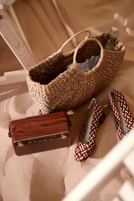 baskets sit beside a purse and heels on a bed