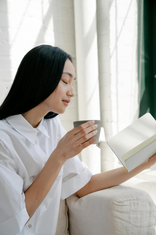 a woman that is sitting down with a book