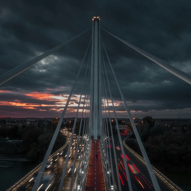 a bridge filled with traffic during a cloudy night