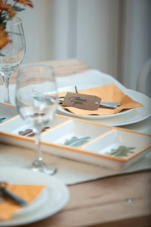 a table with several plates and napkins, one with place settings