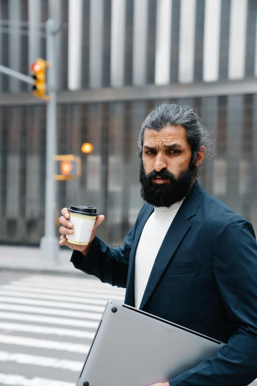 an image of a man holding a cup of coffee
