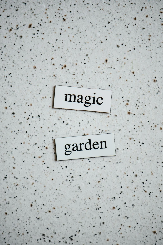 two stickers that say magic and garden