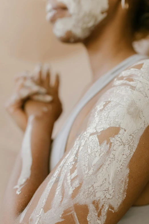 man covered in white powder and shaving his hands