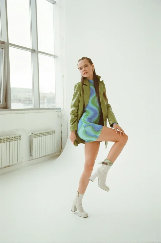  posing in front of a window wearing an off white boots