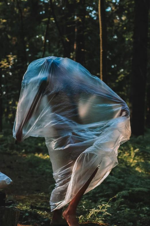 a person in white plastic cloth with a bag