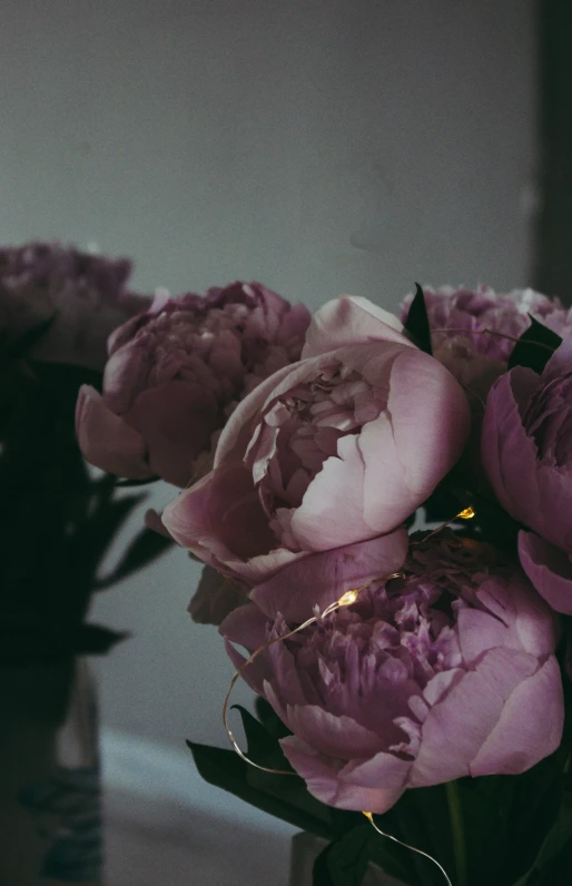 a vase filled with flowers in front of a mirror