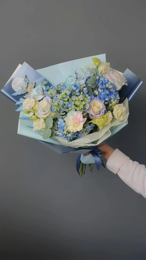 a person holding up a large bouquet of flowers