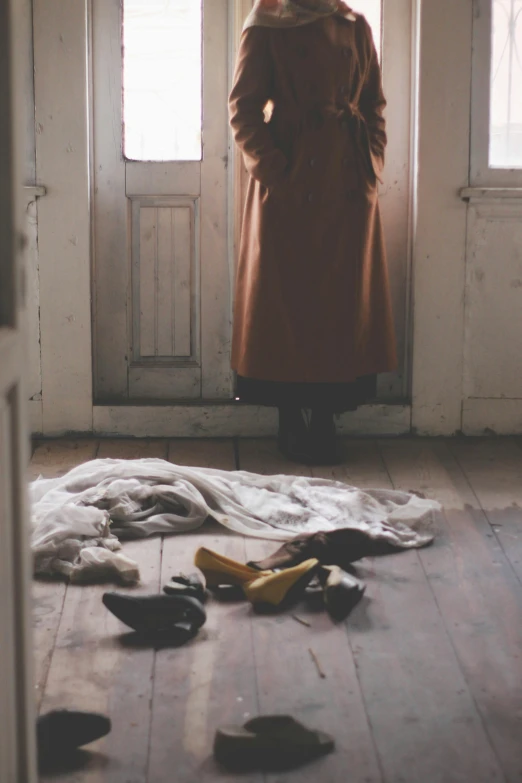 the woman is standing in front of the open door