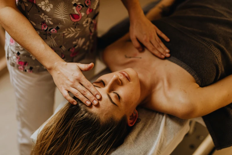 a woman is getting her neck massage from the person at the salon