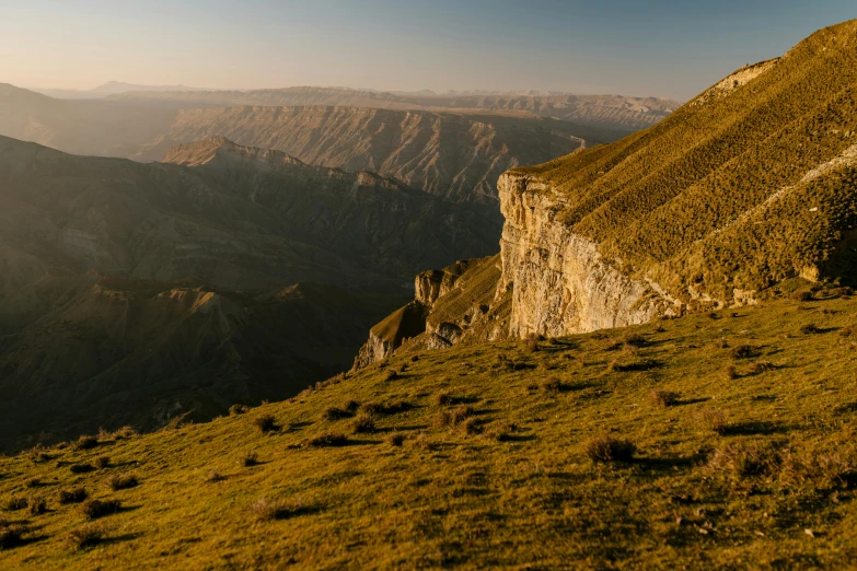 a view of a lush green valley surrounded by mountains