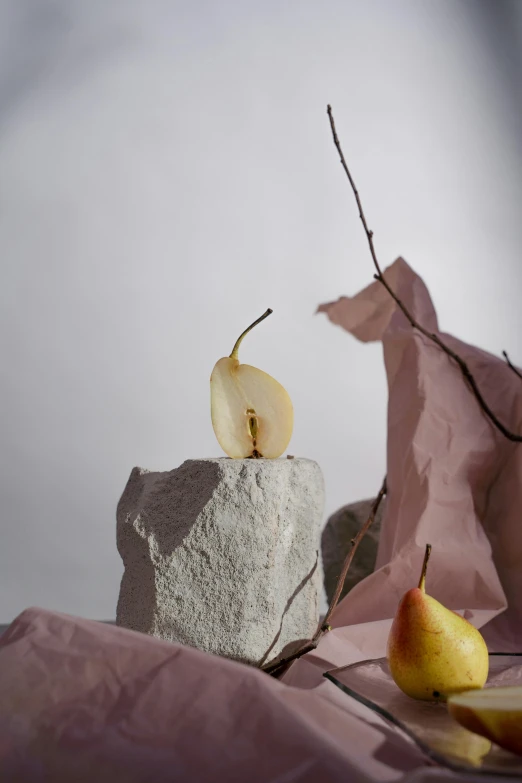 a cake with an apple on top sitting on a pink sheet