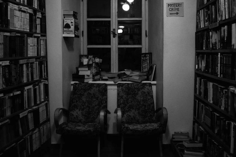 two chairs in a liry full of books