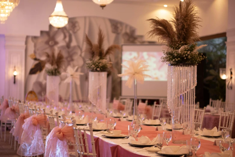 tables decorated for an event with centerpieces and place settings