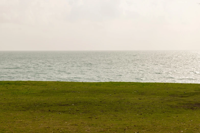 an open field that is close to some water