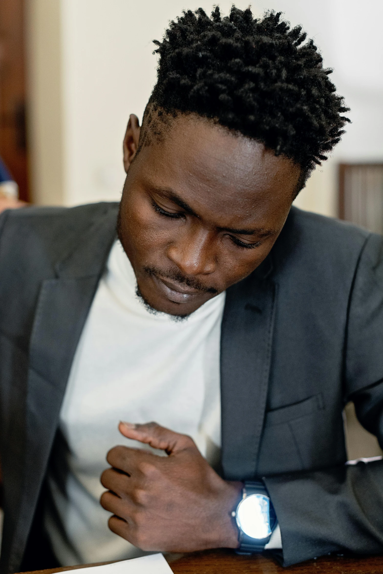 a man in a suit holding his cell phone