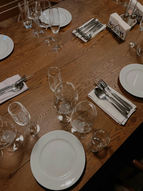 the table is set with empty dishes for four