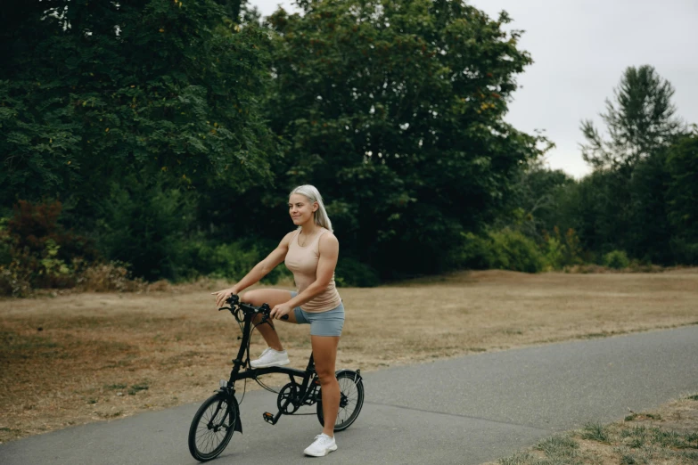 a young woman riding a bicycle with a ponytail on