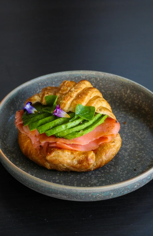 a small pastry sits on a black and gray plate