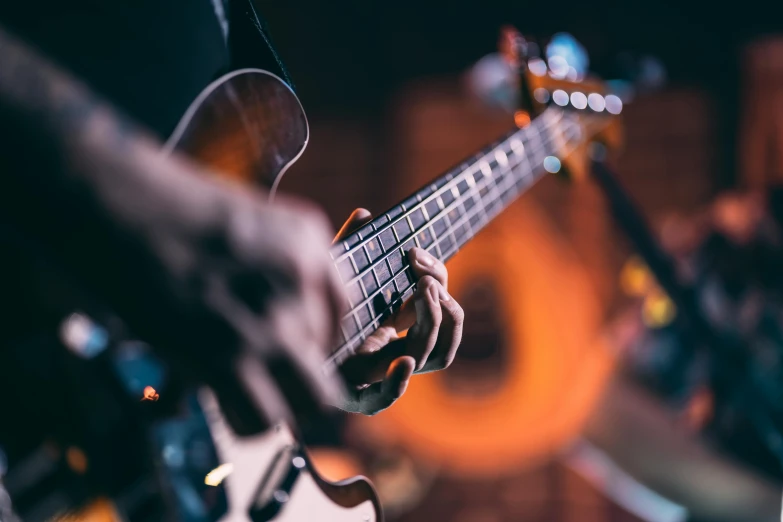 a person holding a guitar playing a song