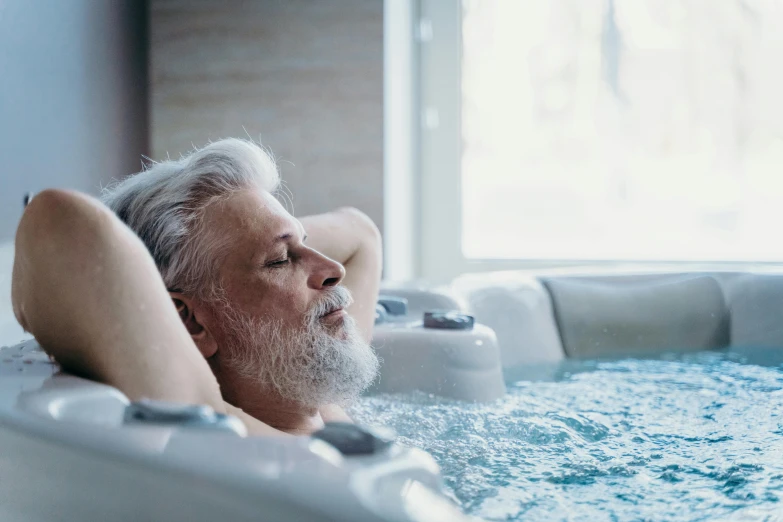 a man relaxing in a large  tub
