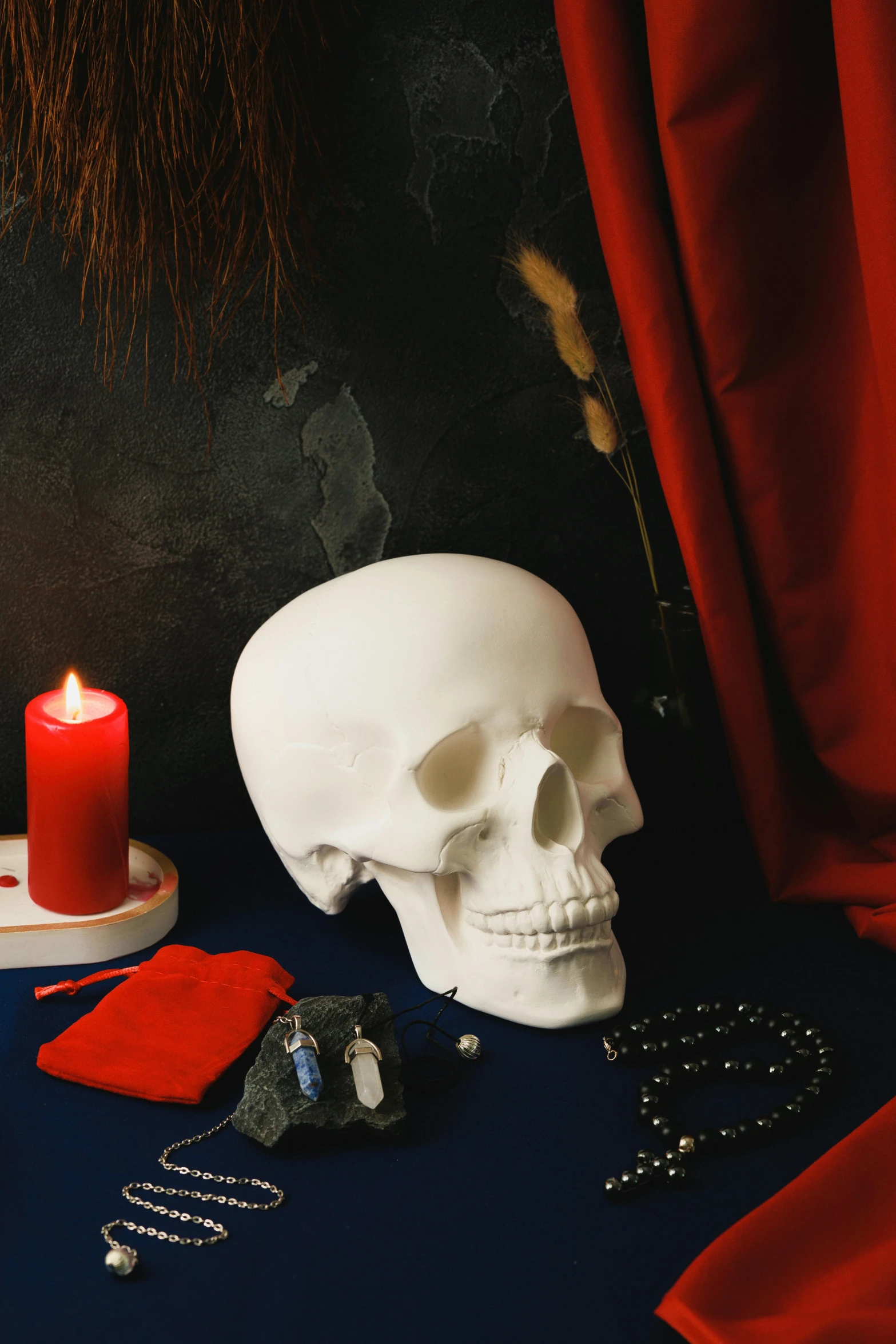 the skull sits on a table with items around it