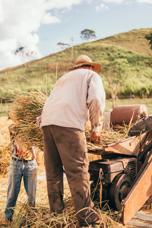 an old man and  working together with a machine