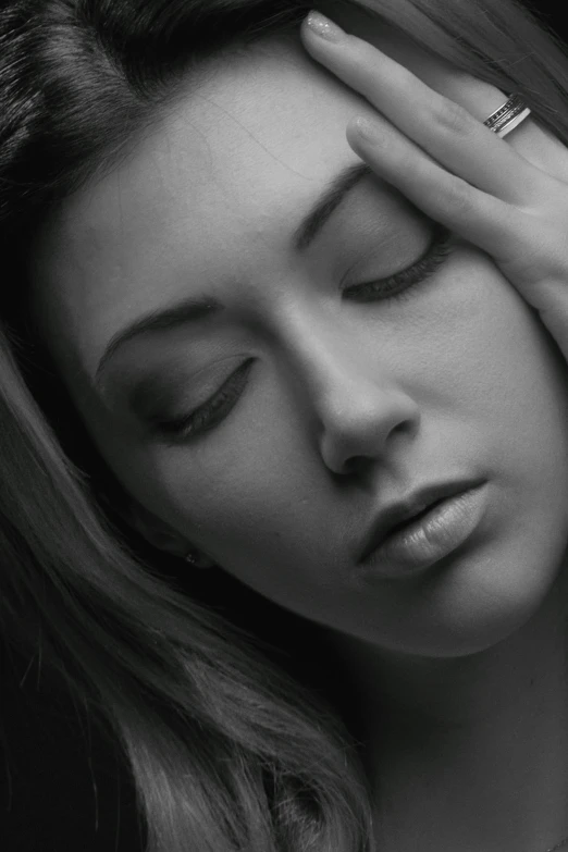 black and white po of a woman holding her head