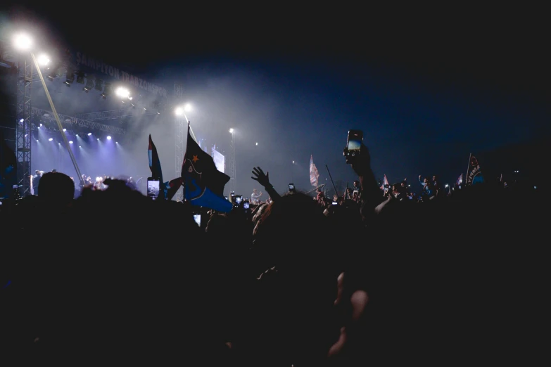 the crowd in the concert is all turned down with their hands in the air