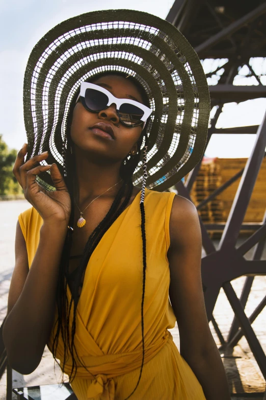 a young woman in sun glasses and head piece with spiraling wire