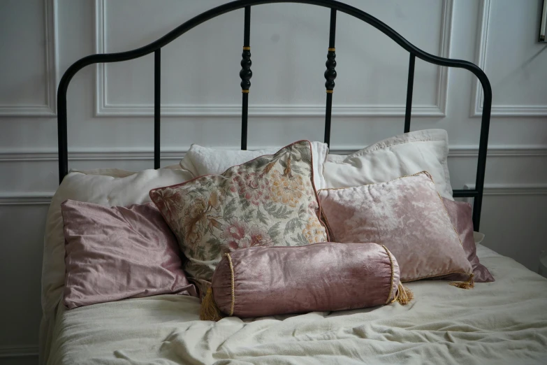 a close up of pillows on top of a bed