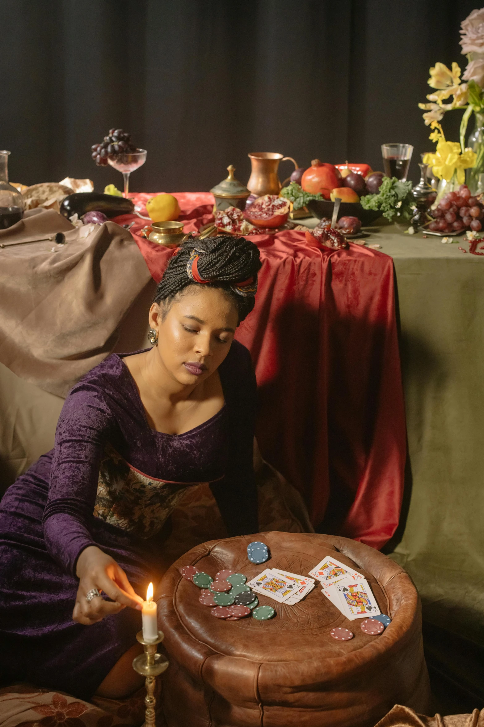 a woman playing with cards next to a table of food