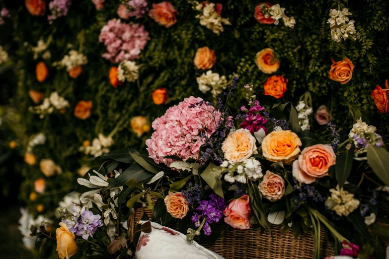 flowers sit in a basket on the ground