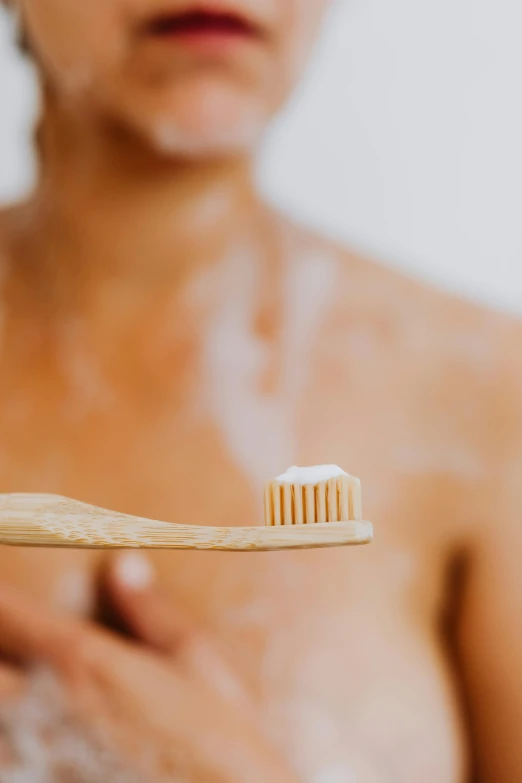 the tooth brush is next to a woman's body