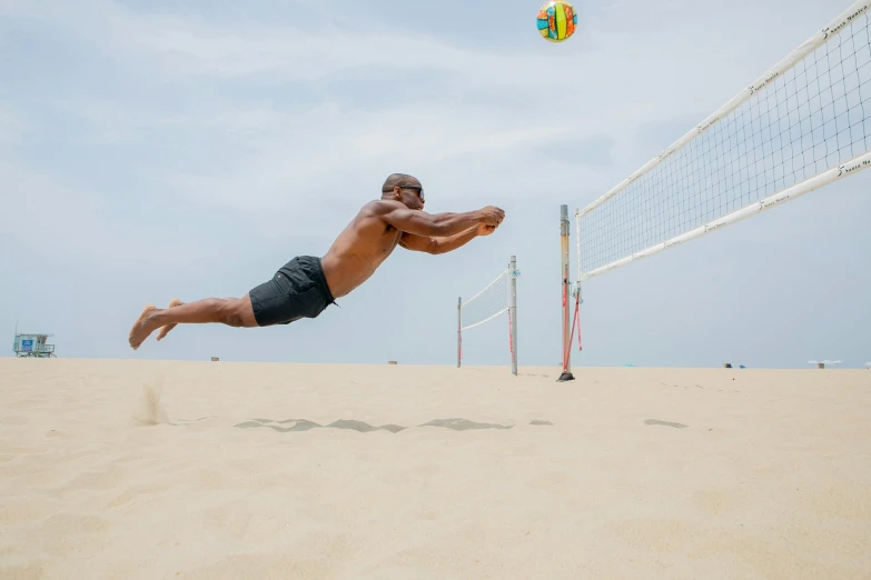 a man is leaping into the air for a volley