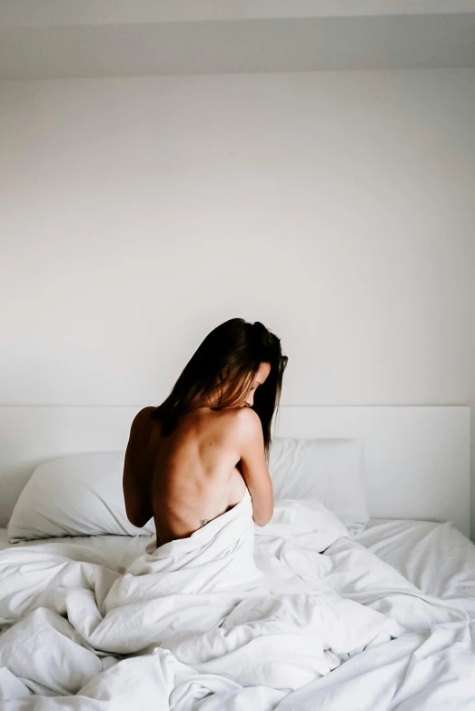  girl sitting on a bed in a bedroom