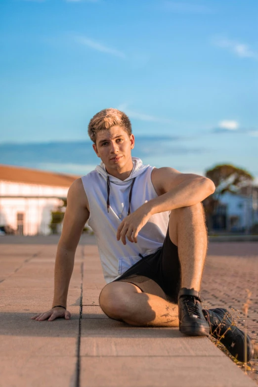 a man sitting on the ground with his legs crossed