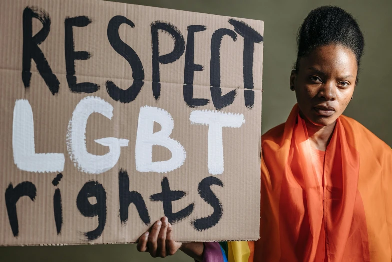 a woman is holding a sign with the words respect and light rights on it