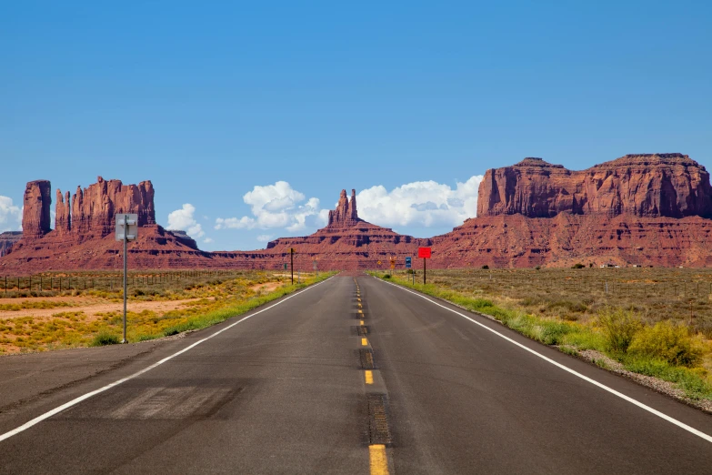 a road surrounded by mountains with signs