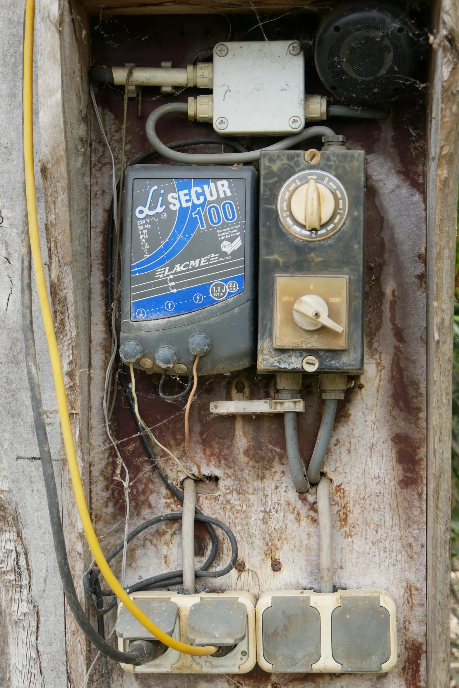 an old electrical panel with wires attached to it
