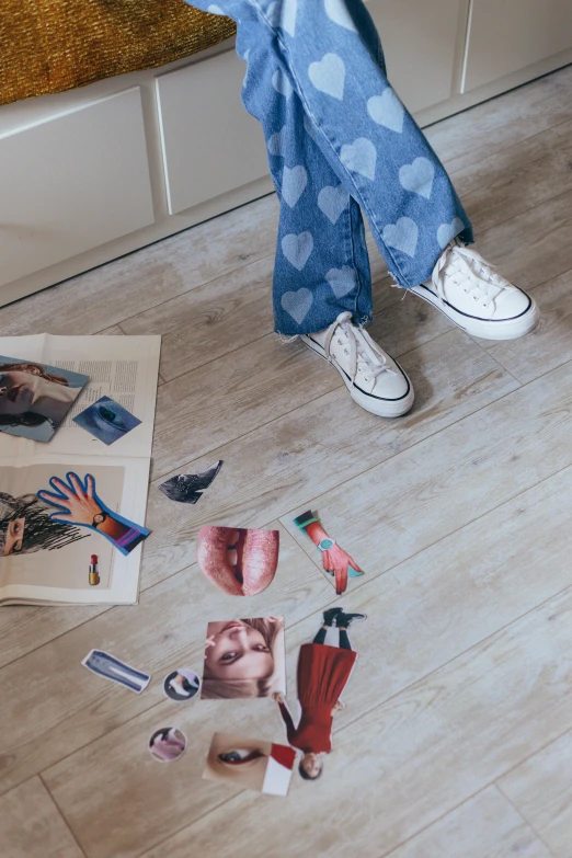 someone with torn pictures and shoes stands on the floor