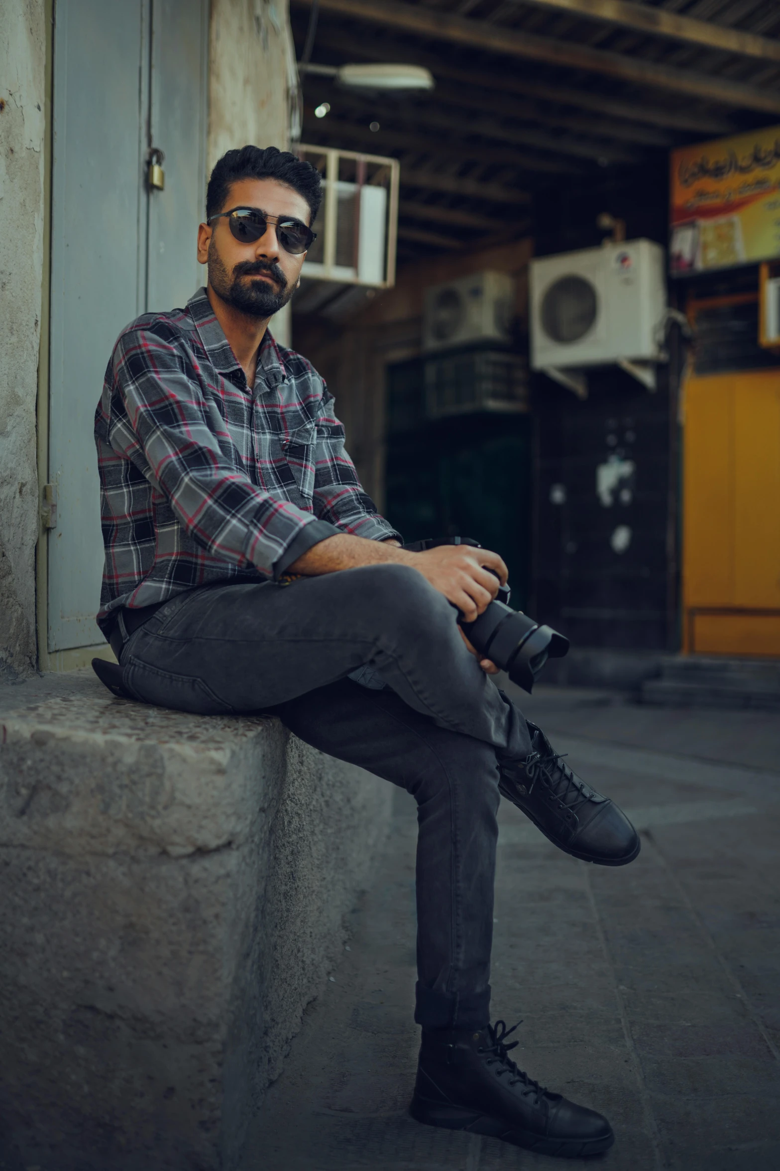 a man sitting down on the steps wearing some shoes