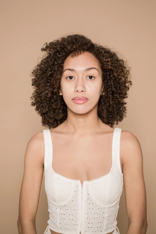 woman with curly hair looking straight into camera